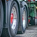 A close up shot of two heavy truck wheels from a rig trailer